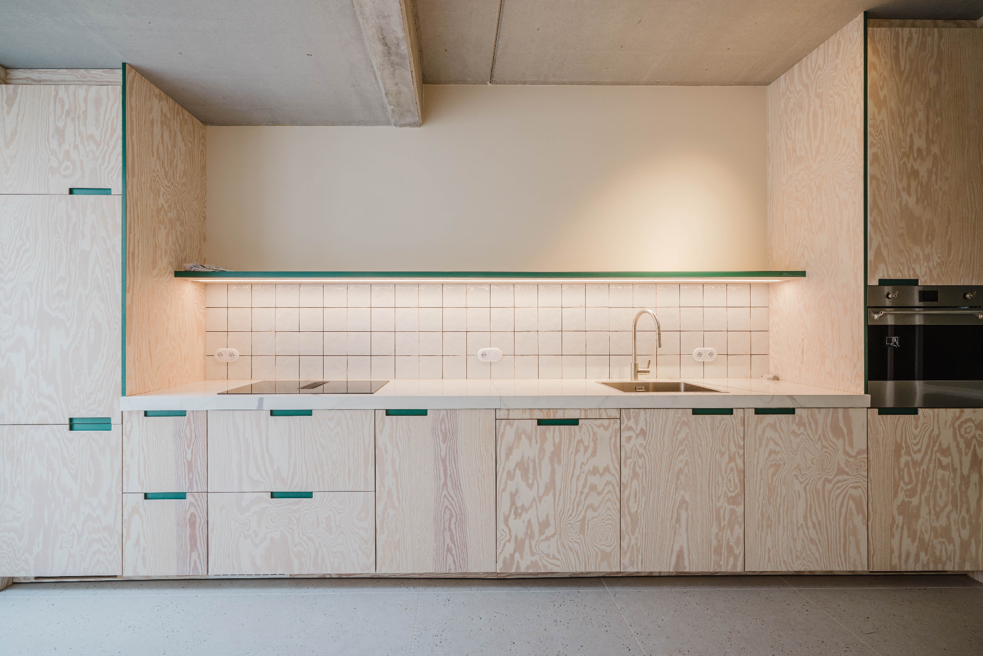 Plywood kitchen with green accents