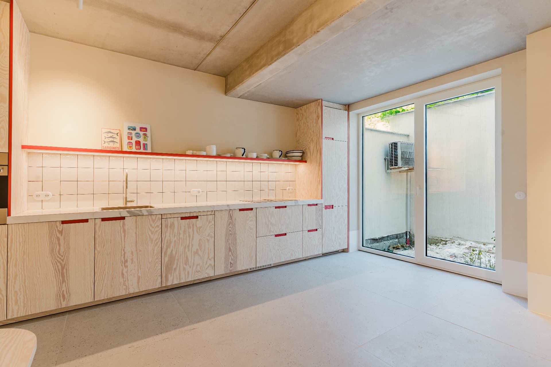 Wide view of the kitchen with tiled walls